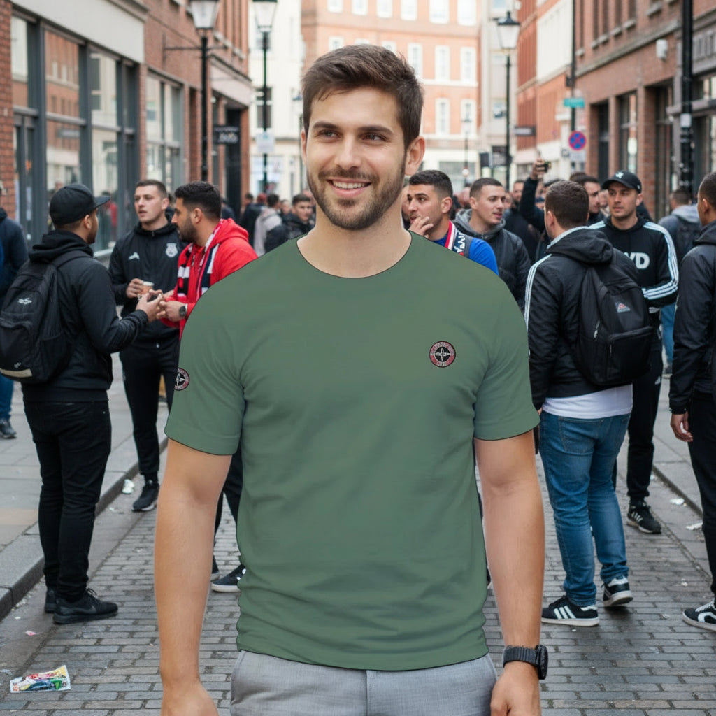 in a green t-shirt in the street with casual football supporters